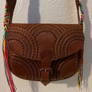 Tooled leather cross body with bright strap